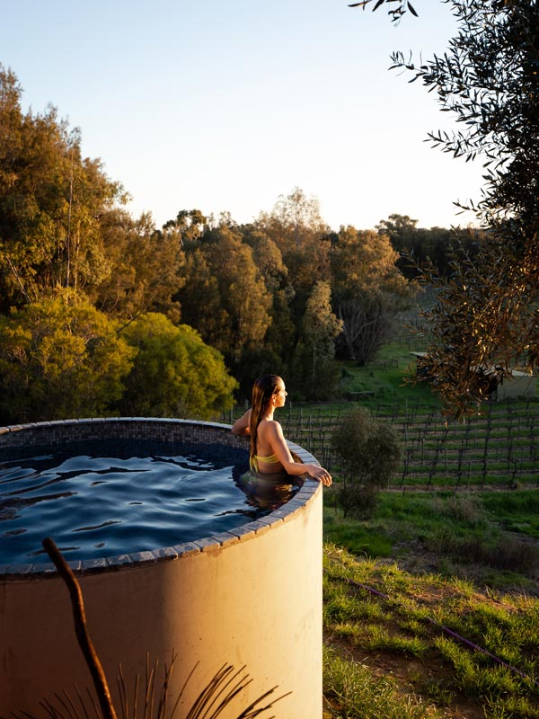 a woman dipping in a heated plunge pool