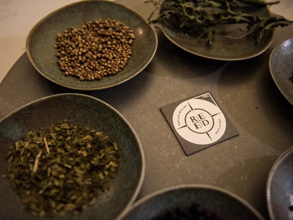 coffee beans and herbs displayed on the table at Reed & Co. Distillery