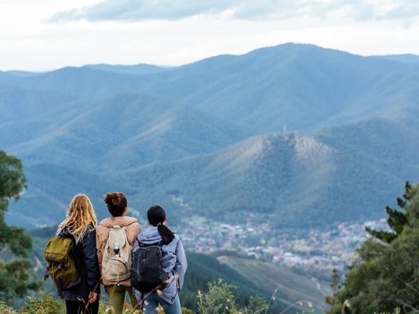 three hikers gazing at the scenic mountain views in Bright