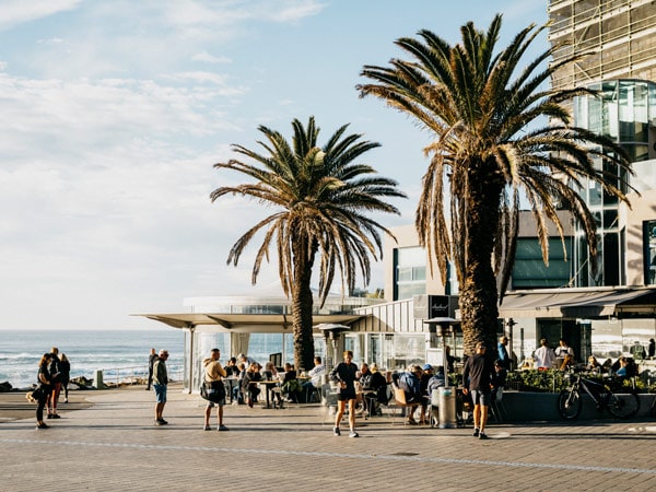 the bustling esplanade in Cronulla filled with crowds of people