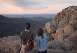 a couple standing atop Booroomba Rocks, Namadgi National Park