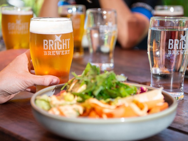 a glass of cold beer alongside a meal at Bright Brewery