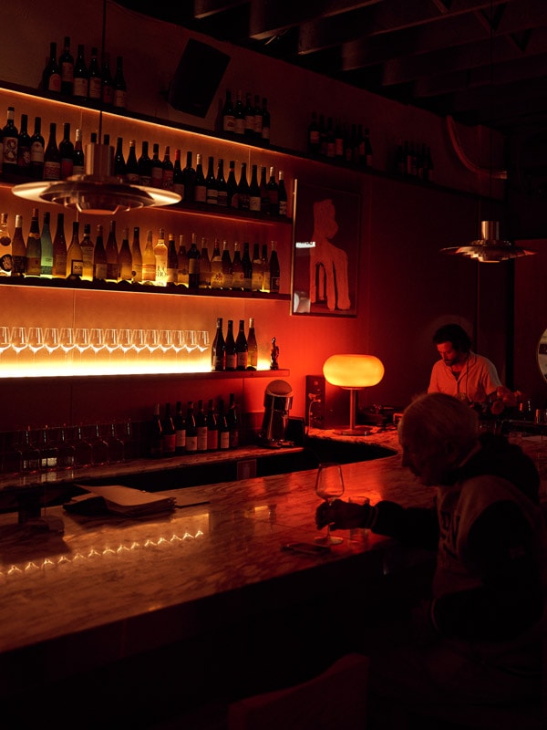 a dim lit bar counter at Pastel Bar