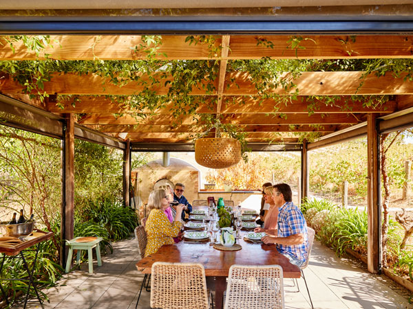 friends dining among the vines at Flaxman Wines