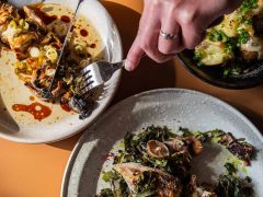 a person using a fork and knife to eat the food in Sonny's Mount Hawthorn