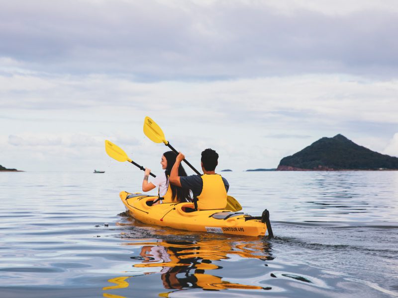 Couple enjoying a day of kayaking along the Karuah River off Jimmys Beach, Hawks Nest.