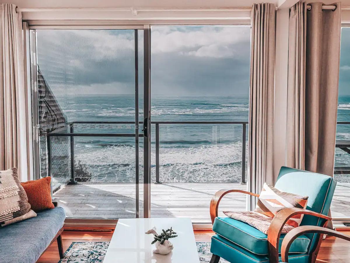 an oceanfront villa with glass windows facing the sea in Pacific Lodge, Yamba