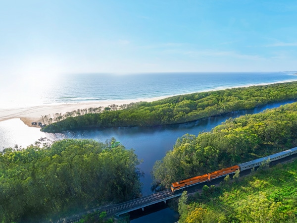 the Indian Pacific train traversing through the coastal town of Coffs Harbour