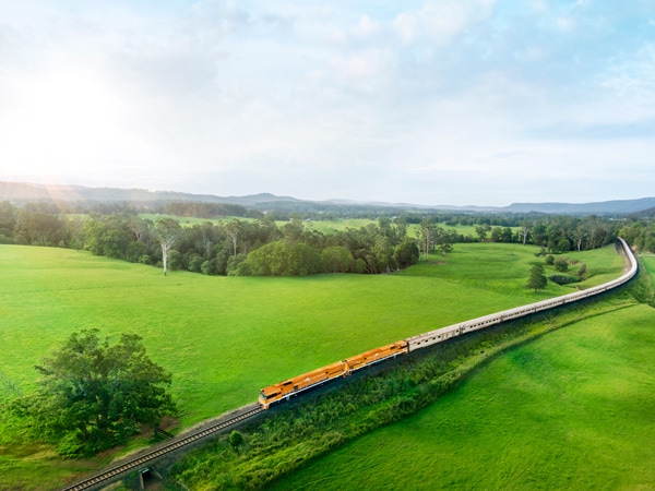 the Great Southern train passing through lush greenery over Victoria and NSW
