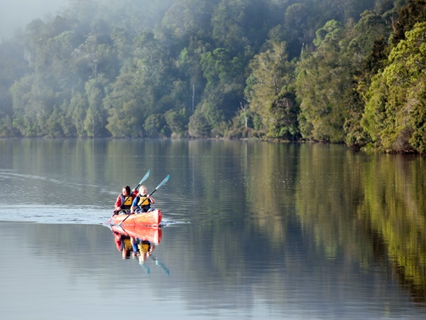 a mother and daughter boating through the waters of Pieman River