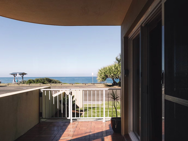 the balcony overlooking the sea at Ocean Sounds, Yamba Airbnb