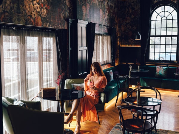 Woman sits inside luxury Ovolo Inchcolm in Brisbane