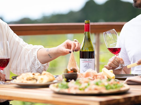 Couple enjoying food at Agostini's restaurant at the Lark Hill Winery in the Canberra region