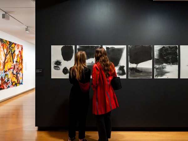 two women looking at artworks on the wall, The Cube, QUT