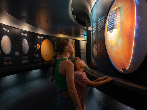 kids learning about the solar system at Sir Thomas Brisbane Planetarium