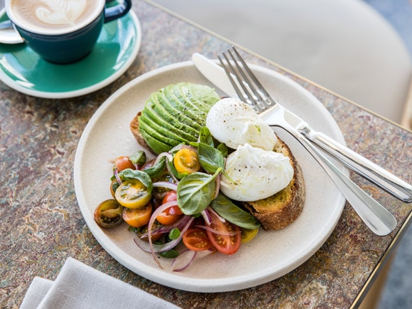 Poached eggs with avocado on sourdough at Three Blue Ducks in Brisbane
