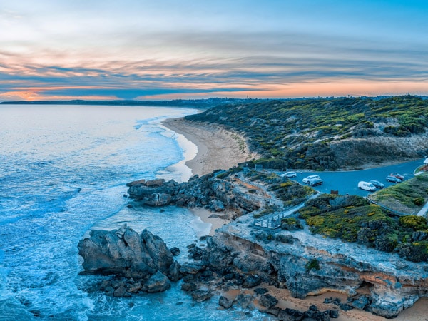 an aerial shot of the Point Richie lookout and beautiful rocks at dusk