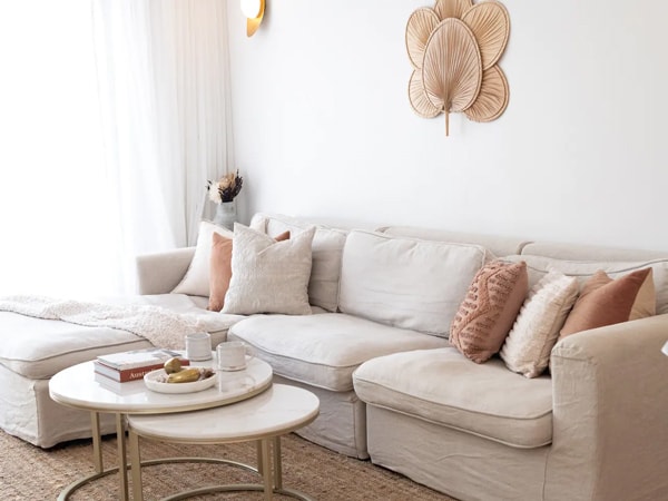 a couch with comfy pillows and cushions at the Beach House, Gold Coast
