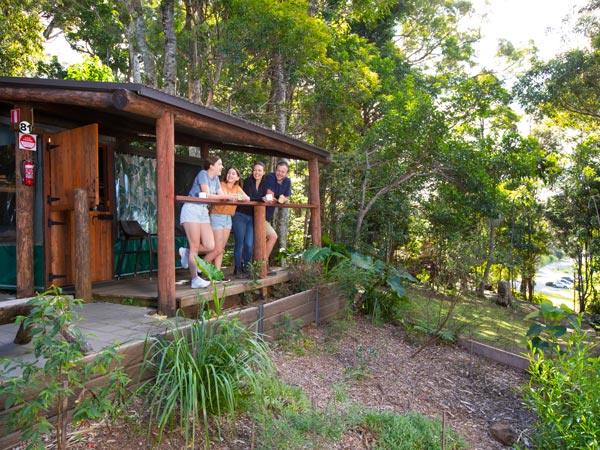 a group of friends hanging out over coffee by the private veranda at Binna Burra Lodge
