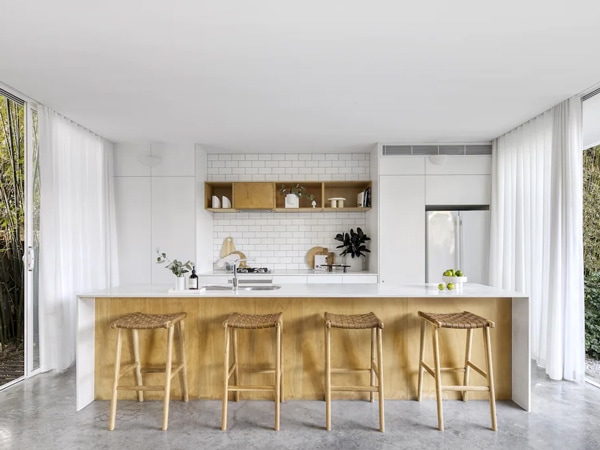 an open-plan kitchen area with stools