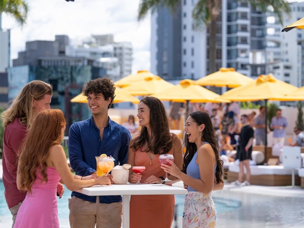 friends enjoying drinks by the pool at Cali Beach Club, Gold Coast