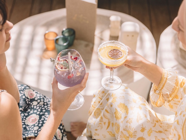 two women enjoying cocktail drinks at Destino Wine Bar