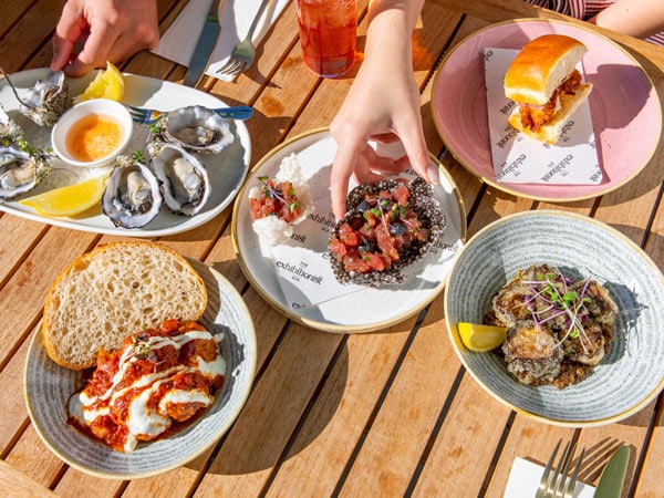 a table top view of meals at Exhibitionist Bar