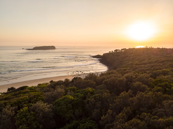 Sun rising over Fingal Head Beach and Cook Island