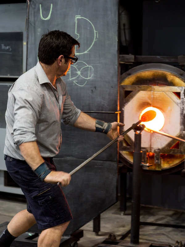 a man glass making in action at Canberra Glassworks