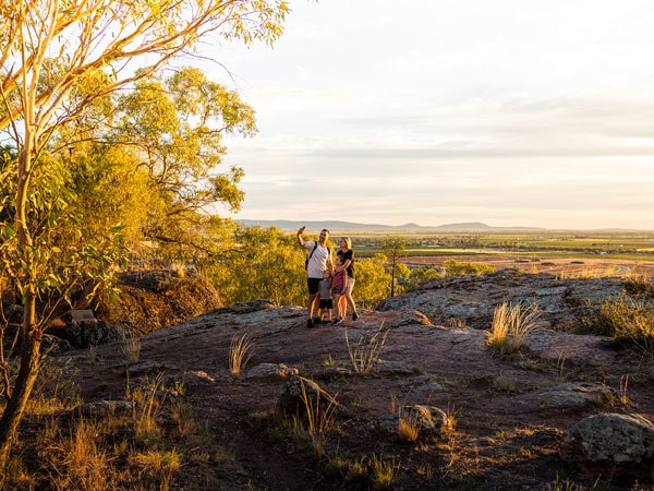 a family taking a photo atop the Griffith Scenic Hill