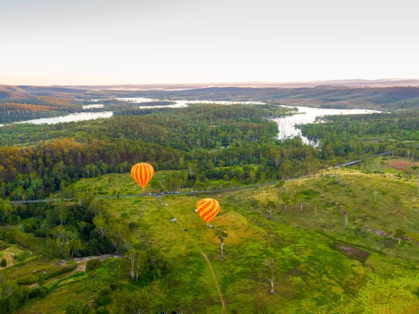 hot air balloons float across the vineyard landscape in Gold Coast