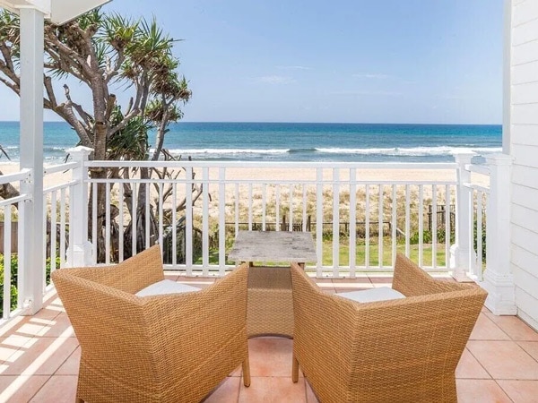 a balcony with two seats facing the sea at Jabiru, Gold Coast