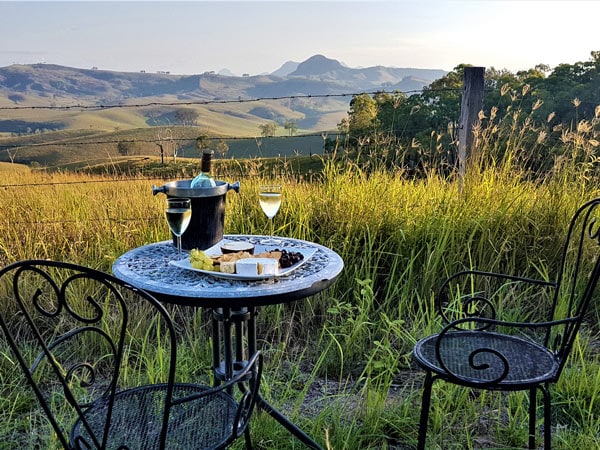 an al fresco dining setup amidst scenic mountain views at Ketchup's Bank Glamping Dining, Gold Coast