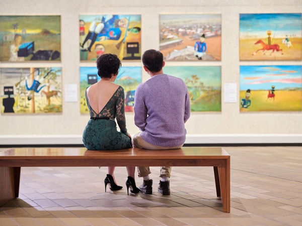 a couple admiring artworks at he National Gallery of Australia in Canberra