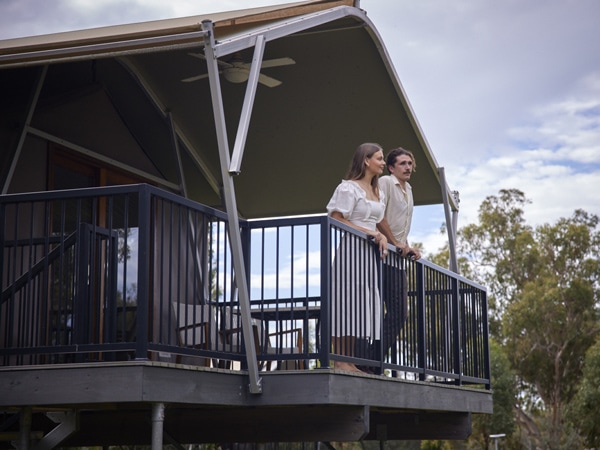 a couple standing on their private balcony at Sanctuary by Sirromet Winery, Gold Coast
