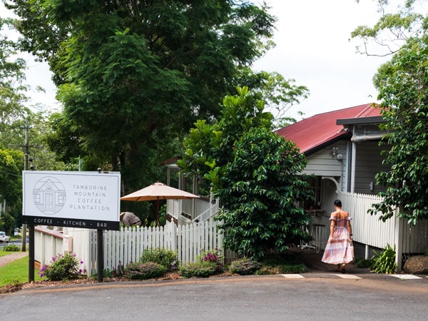 a woman entering the Tamborine Mountain Coffee Plantation