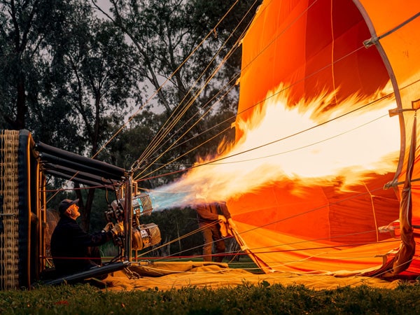 a man firing a hot air balloon in Barossa Valley