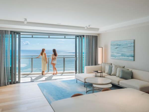 two women standing on the balcony admiring scenic sea views at The Langham Gold Coast