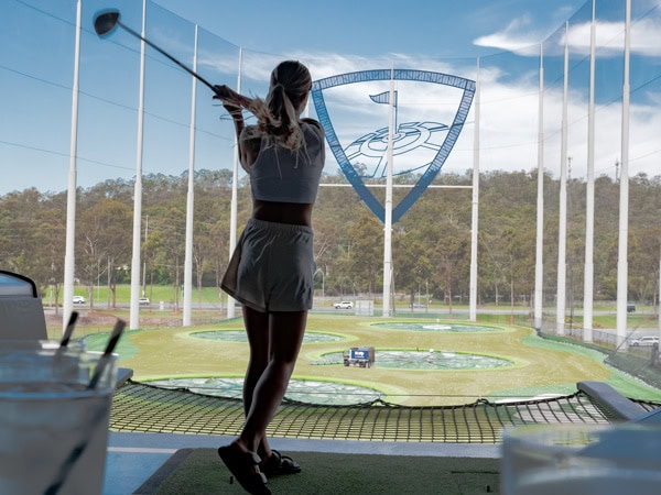 a woman playing golf at Topgolf Gold Coast