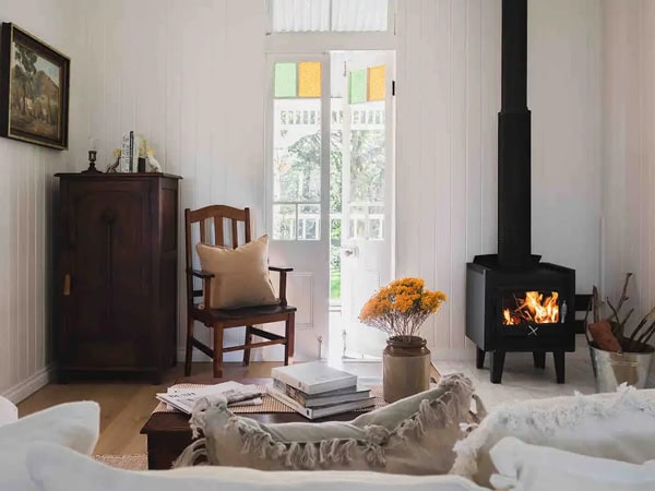 a living room with a fireplace at Wattle Cottage