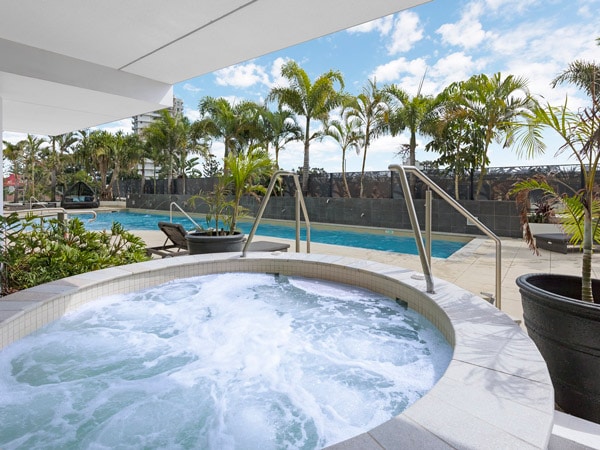 a jacuzzi beside the pool at Wyndham Surfers Paradise Spa