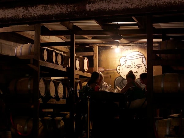 friends drinking inside the dimly lit Grandad Jack’s, Miami