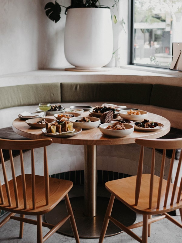 Table filled with vegetarian and vegan food, cocktails from herbert in Noosa, Queensland.