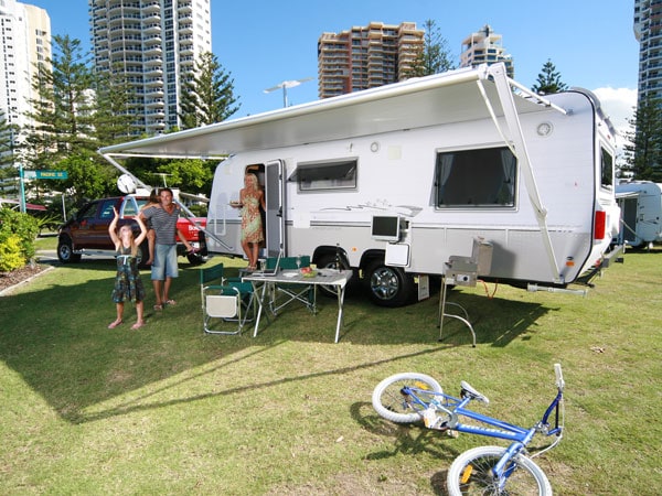 a family in a caravan set in a powered site at Main Beach Tourist Park