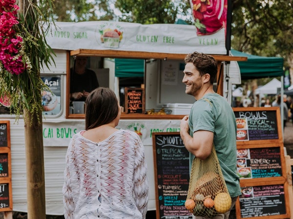 a couple shopping for fresh produce at Noosa Farmers Market