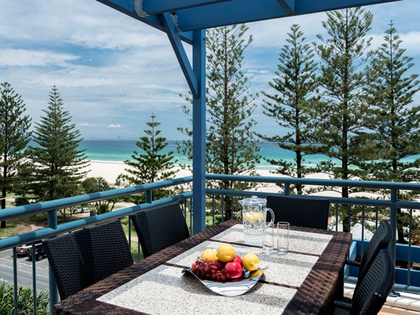 an beachfront dining with a balcony at Oaks Gold Coast Calypso Plaza Suites