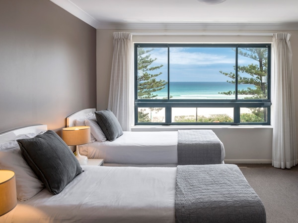 a bedroom with scenic beach views at Oaks Gold Coast Calypso Plaza Suites
