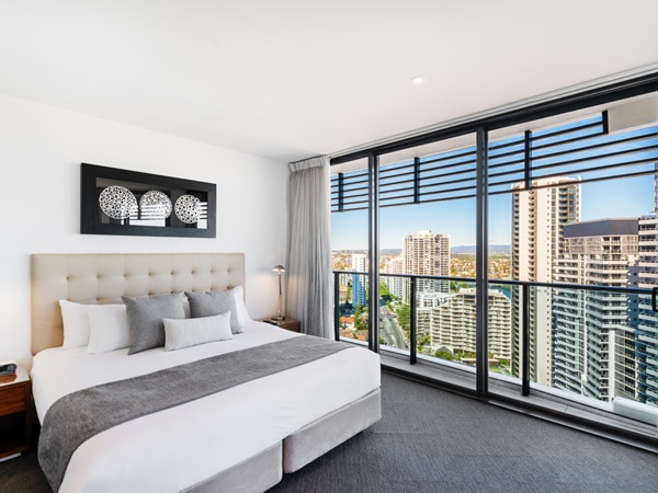 a bedroom with balcony at Peppers Broadbeach