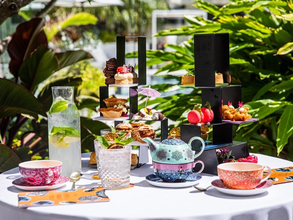 an assortment of sweet treats and drinks on the table at FIXX Cafe at QT Gold Coast