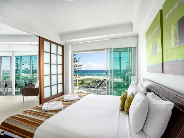 a spacious bedroom with sea view balcony